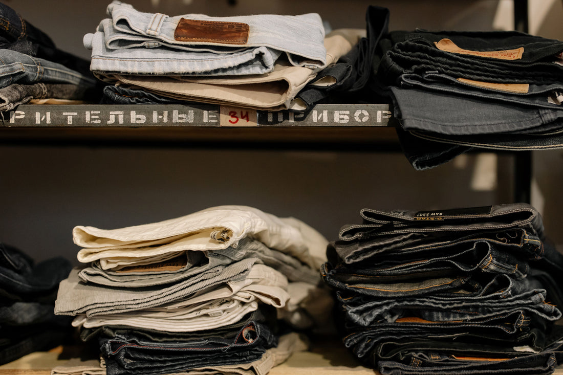 Men's jeans neatly folded on a shelf