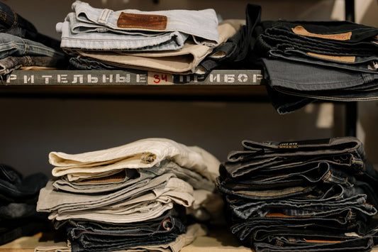Men's jeans neatly folded on a shelf