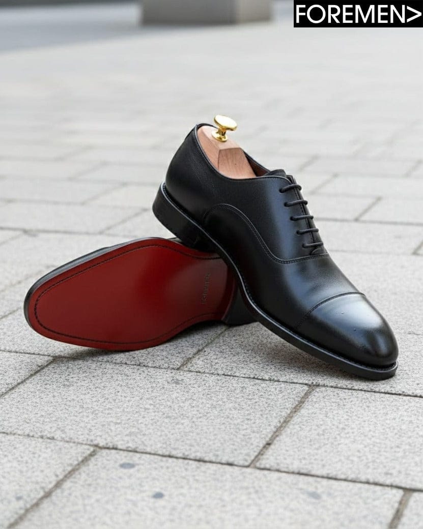 Black dress shoes with red sole