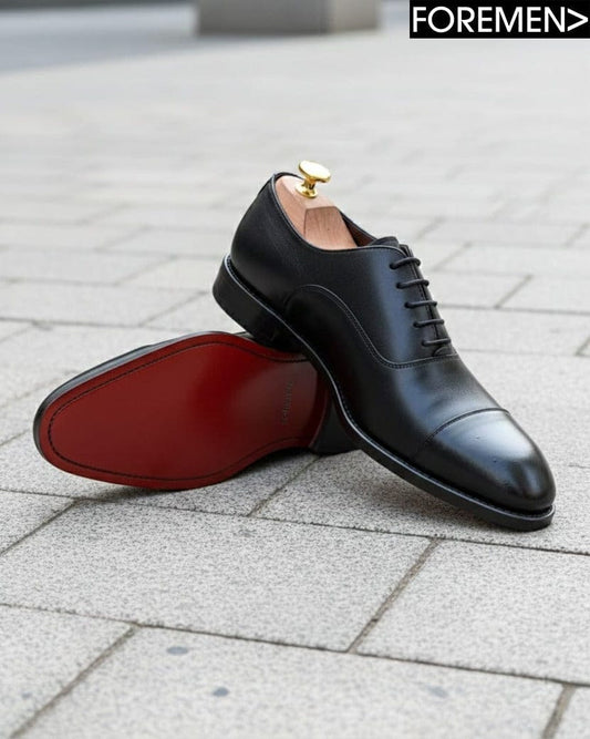 Black dress shoes with red sole